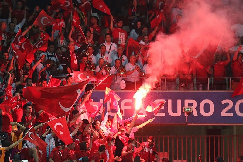 Turkish supporters wave the national flag and a flare during Euro 2016 group football match between Spain and Turkey at the Allianz Riviera stadium in Nice on June 17, 2016. (AFP)