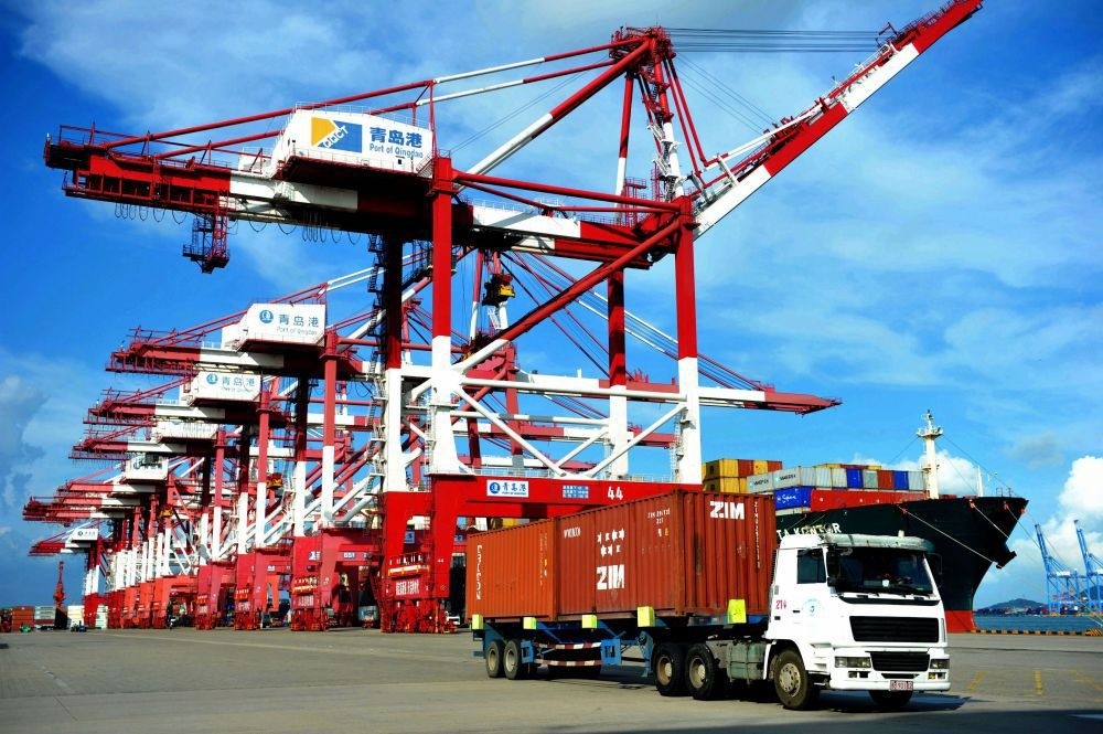 A truck transports containers at a port in Qingdao, eastern China's Shandong province.