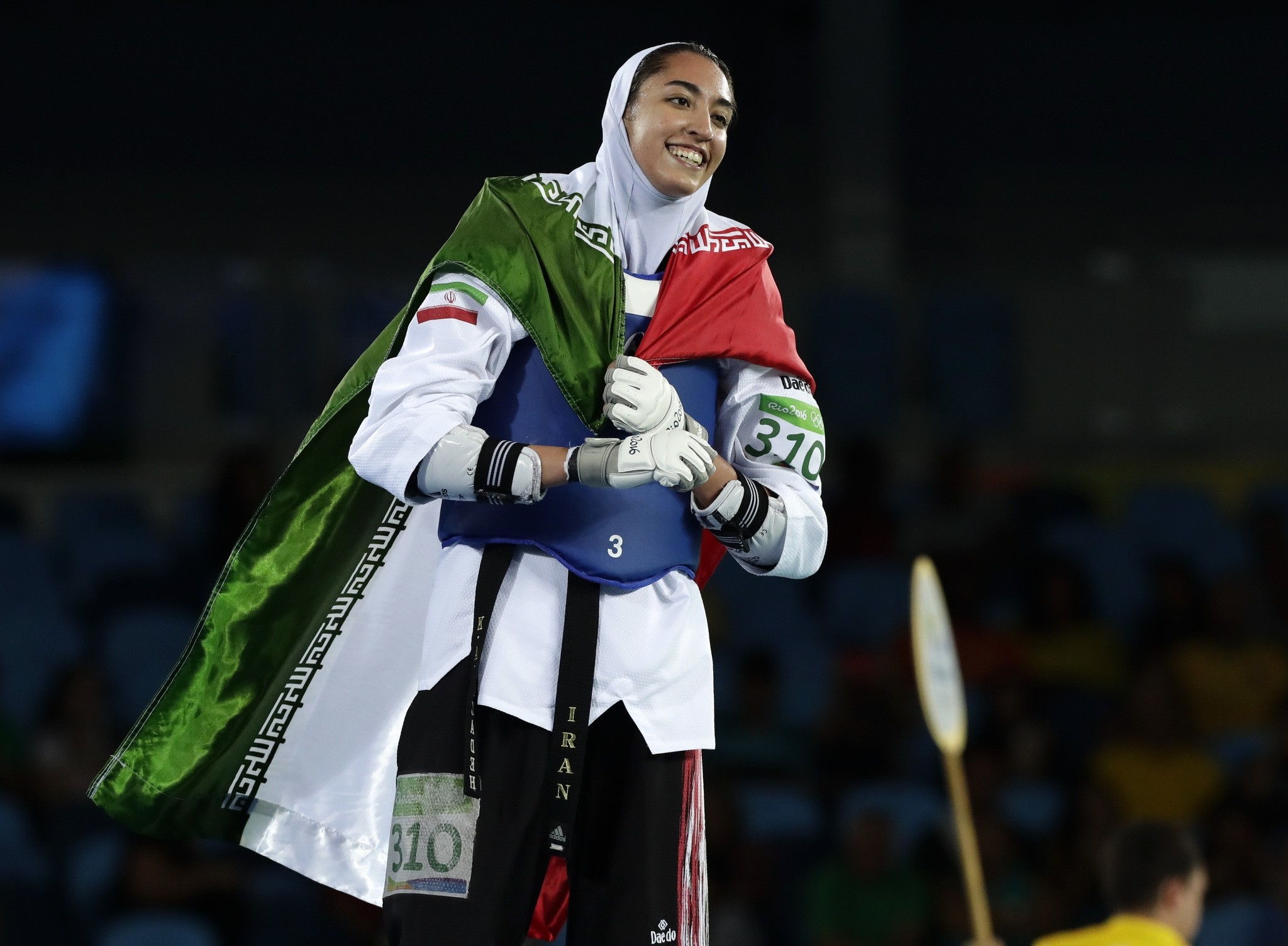 Kimia Alizadeh Zenoorin, of Iran, celebrates after winning a bronze medal in women's 57-kg taekwondo competition at the 2016 Summer Olympics in Rio de Janeiro, Brazil, Thursday, Aug. 18, 2016. (AP Photo)