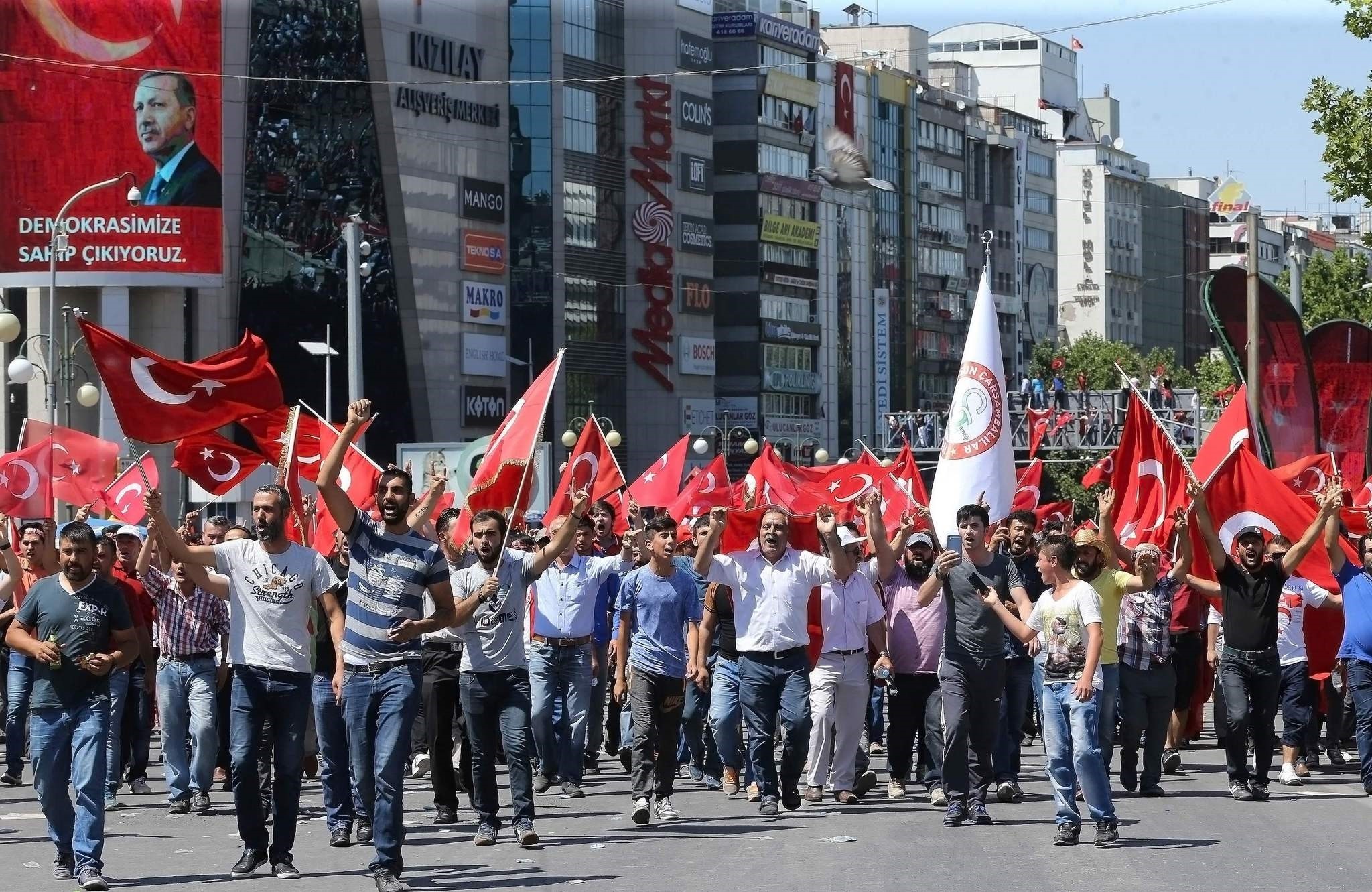  People wave national flags as they march from Kizilay square to Turkish General Staff building to react against military coup attempt, in Ankara, on July 16, 2016.