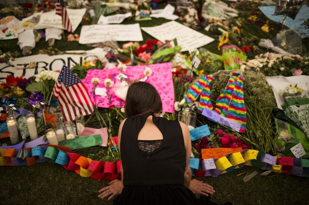 A woman visits a memorial in honor to the victims of the Orlando mass shooting outside the Dr. Phillips Center for the Performing Arts in Orlando, Florida, June14.