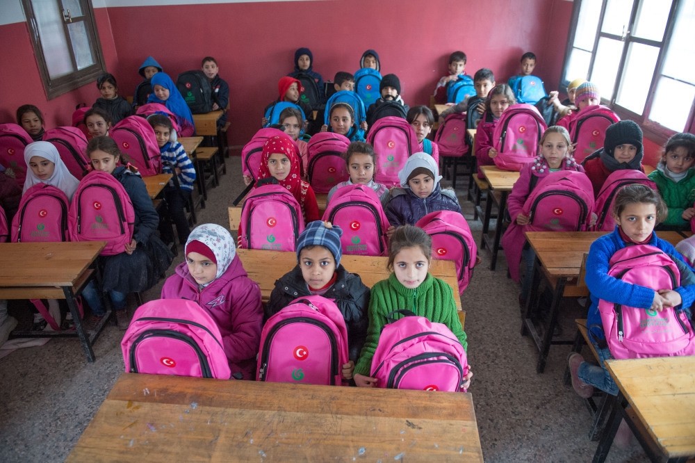 Children at a school restored by Turkey in Jarablus show school bags donated by a Turkish charity.