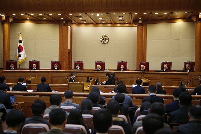 Nine judges sit during the first hearing arguments for South Korean President Park Geun-hye's impeachment trial at the Constitutional Court in Seoul, South Korea, Tuesday, Jan. 3, 2017. (AP Photo)