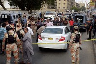 Pakistani investigators and journalists gather around the blood-stained car of famous Sufi singer Amjad Sabri after an attack in Karachi, Pakistan, Wednesday, June 22, 2016. (AP Photo)