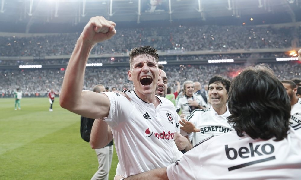 Mario Gomez celebrates with team members after winning the Super League Championship.