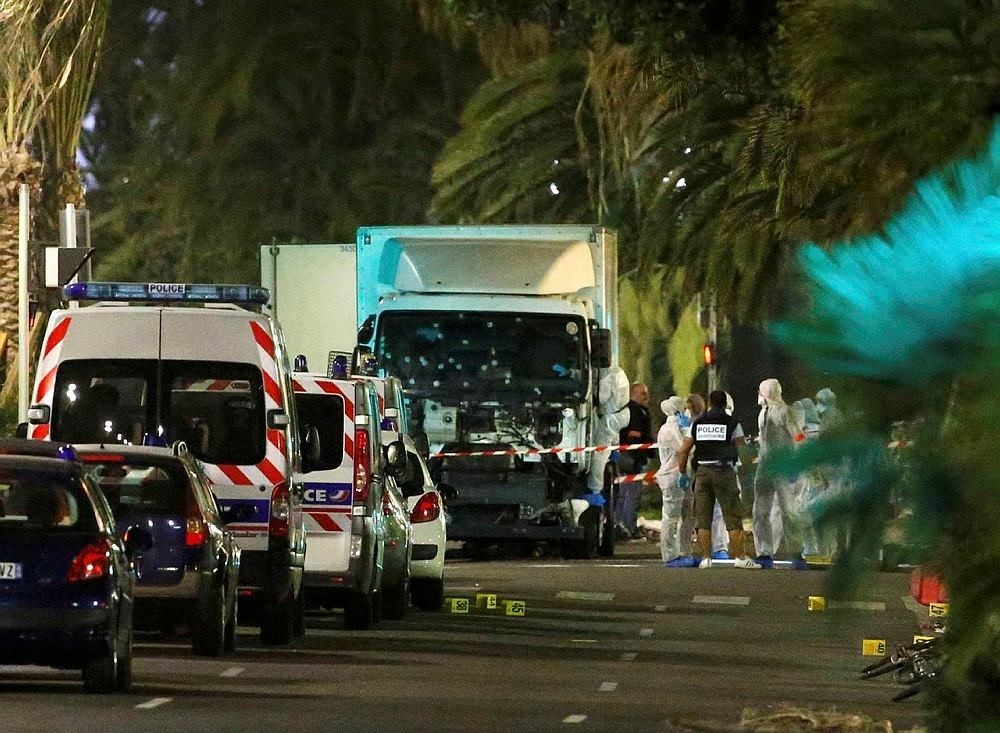 French police forces and forensic officers stand next to a truck July 15, 2016 that ran into a crowd celebrating the Bastille Day national holiday on the Promenade des Anglais killing at least 60 people in Nice, France, July 14. (Reuters Photo)