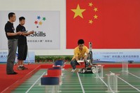 A participant operates a robot during a competition in Wuhu, Anhui province.