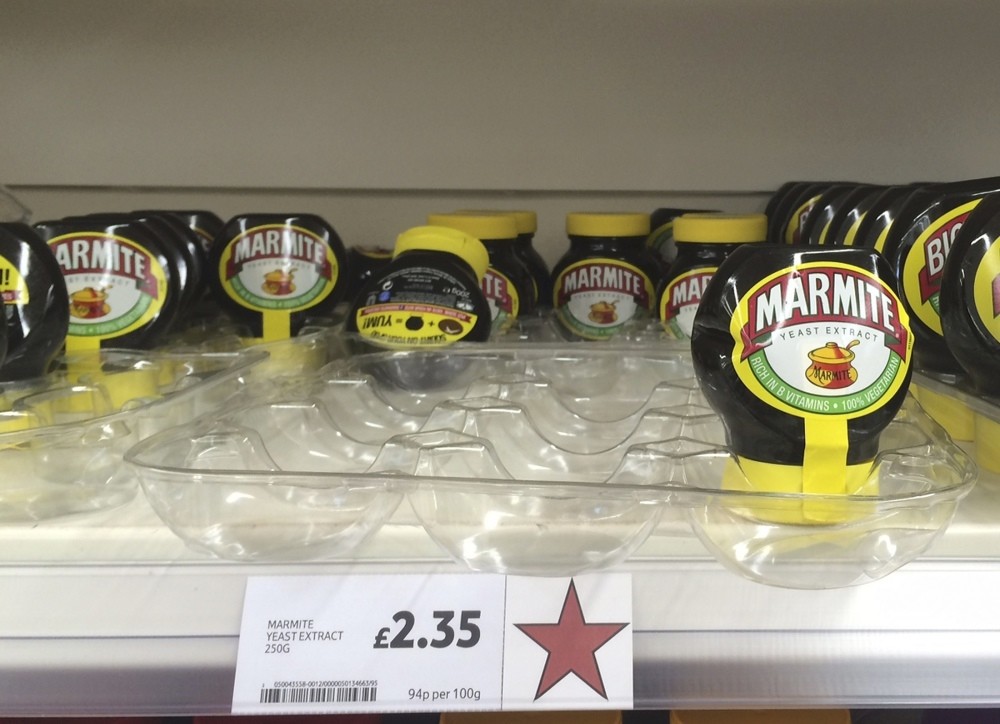 Jars of Marmite, a brand of Unilever, are displayed for sale on a shelf at a Tesco supermarket in Basildon, Britain.