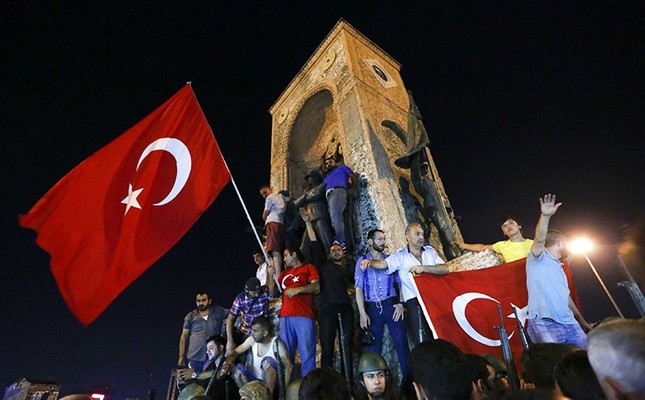 People wave flags as they demonstrate in the Taksim Square in Istanbul, Turkey, July 16, 2016. (Reuters Photo)