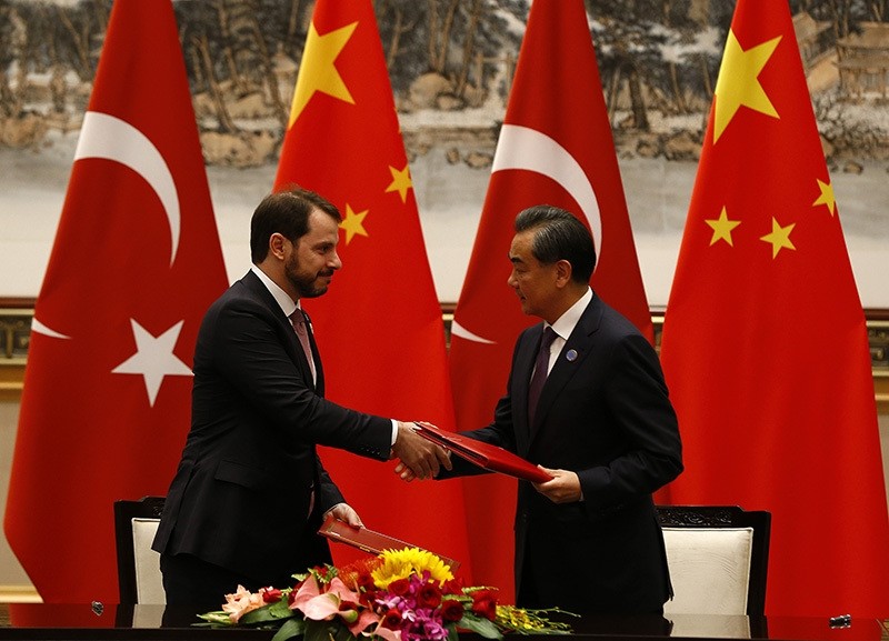 Turkish Energy Minister Berat Albayrak (L) and Chinese Foreign Minister Wang Yi shake hands during the signing ceremony. (AA Photo)