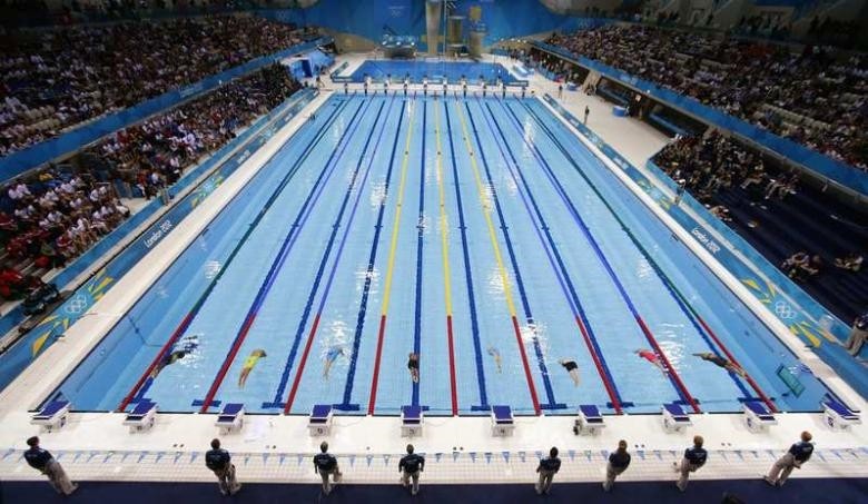 Swimmers dive into the water to start the womenu2019s 50m freestyle event during the London 2012 Olympic Games.