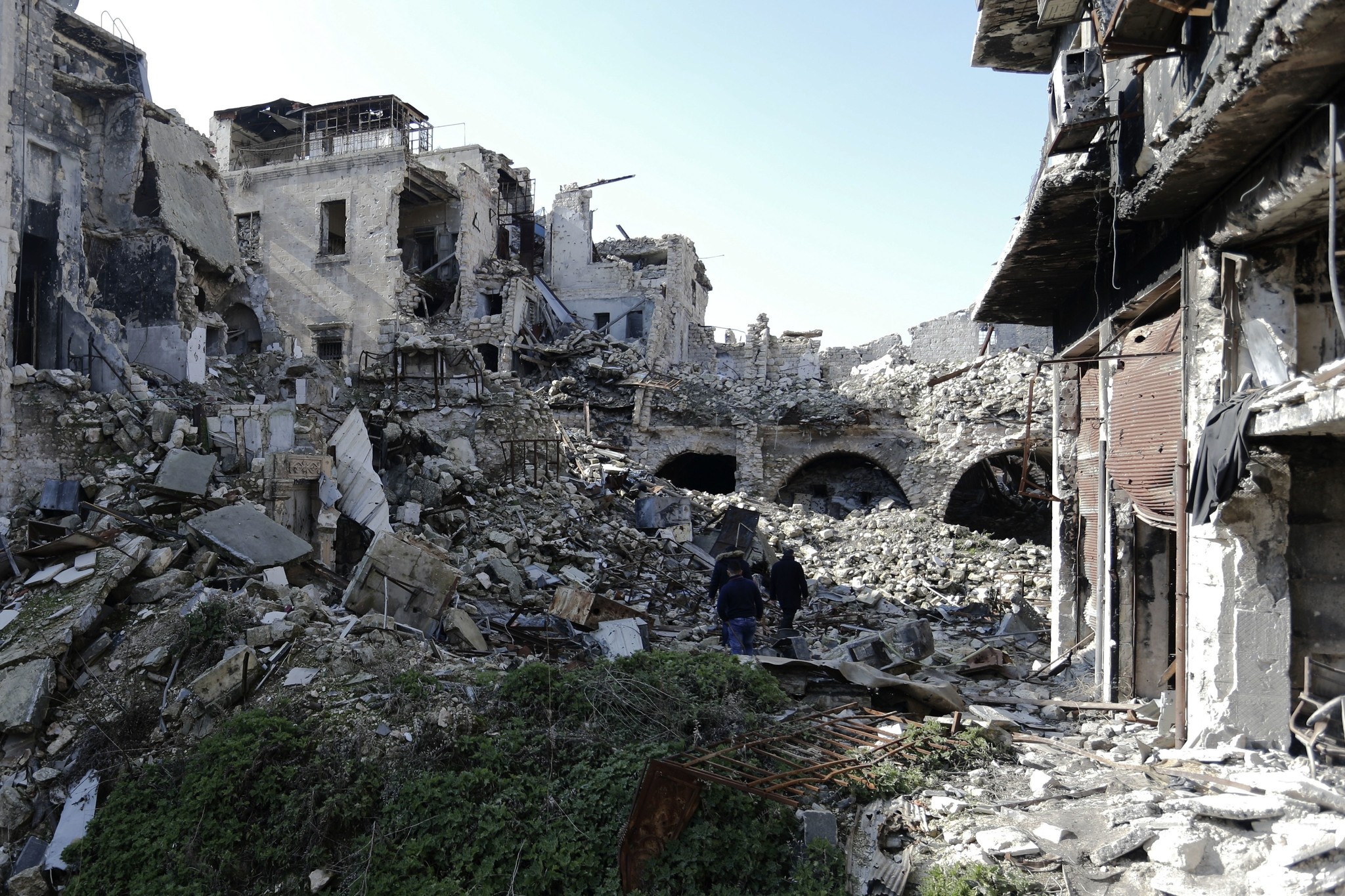Syrians walk through the destruction in the old city of Aleppo, Syria, Saturday, Jan. 21, 2017. (AP Photo)