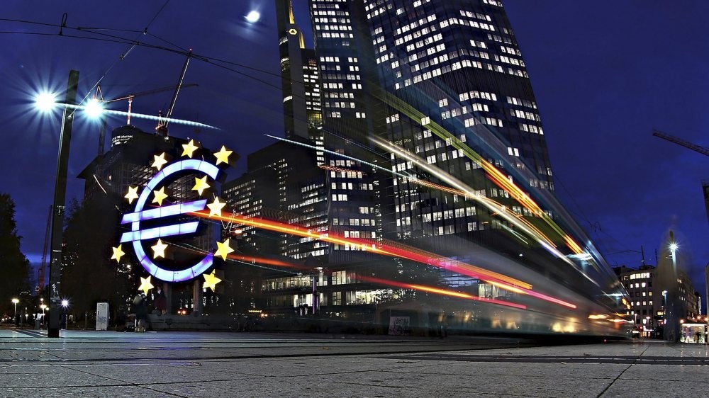 The giant Euro symbol stands illuminated outside the headquarters of European Central Bank (ECB)