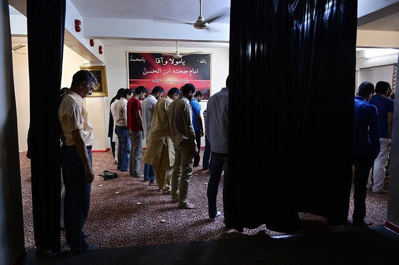 Muslim Shia migrants in Greece pray during the celebrations of Eid al-Fitr marking the end of the fasting month of Ramadan, at a makeshift mosque near the port of Piraeus on July 6, 2016. (AFP)