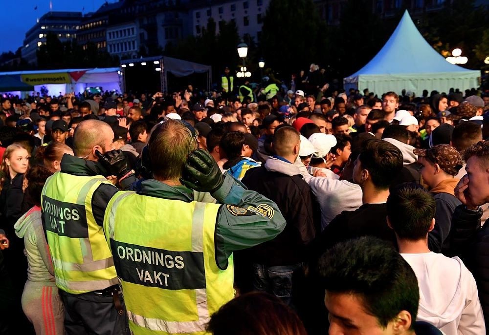 Security staff survey the scene at the ,We are Stockholm, festival in central Stockholm, Sweden, Thursday Aug. 18, 2016. (TT via AP)