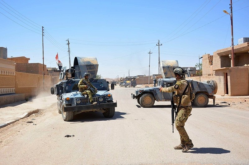 Iraqi government forces monitor a street on May 19, 2016 in the western town of Rutba after they recaptured it from the Daesh group. (AP Photo)