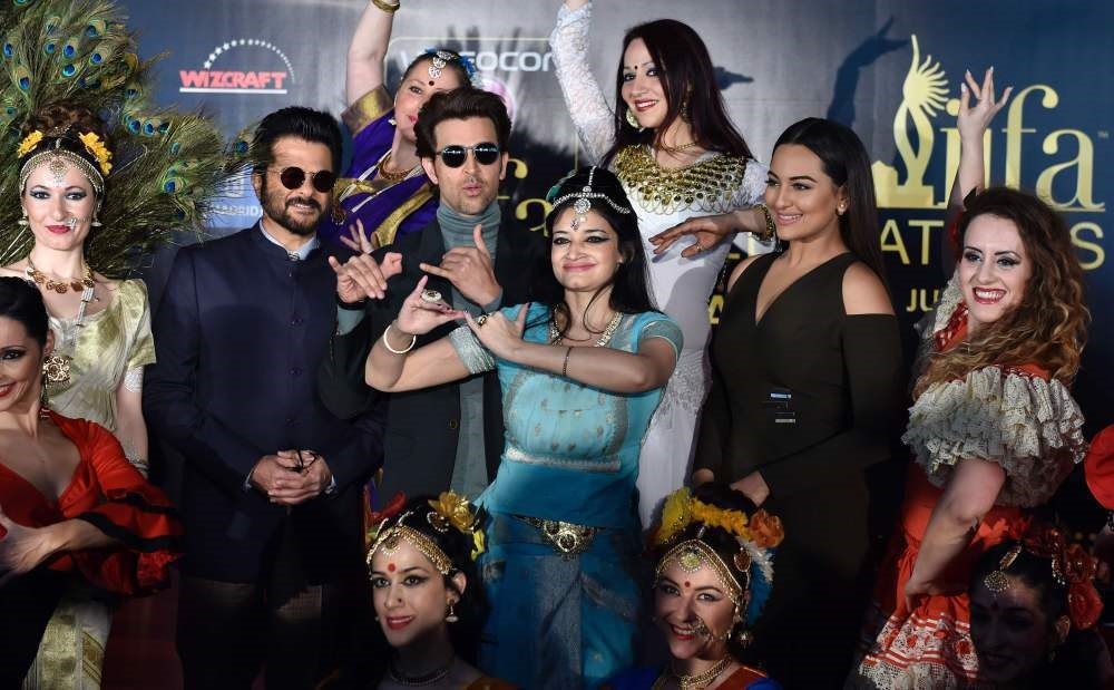 Indian actors Anil Kapoor (2ndL), Hrithik Roshan (3rdL) and Sonakshi Sinha (2ndR) pose with dancers before a press conference held to present the Bollywood Oscars in Madrid on March 14.