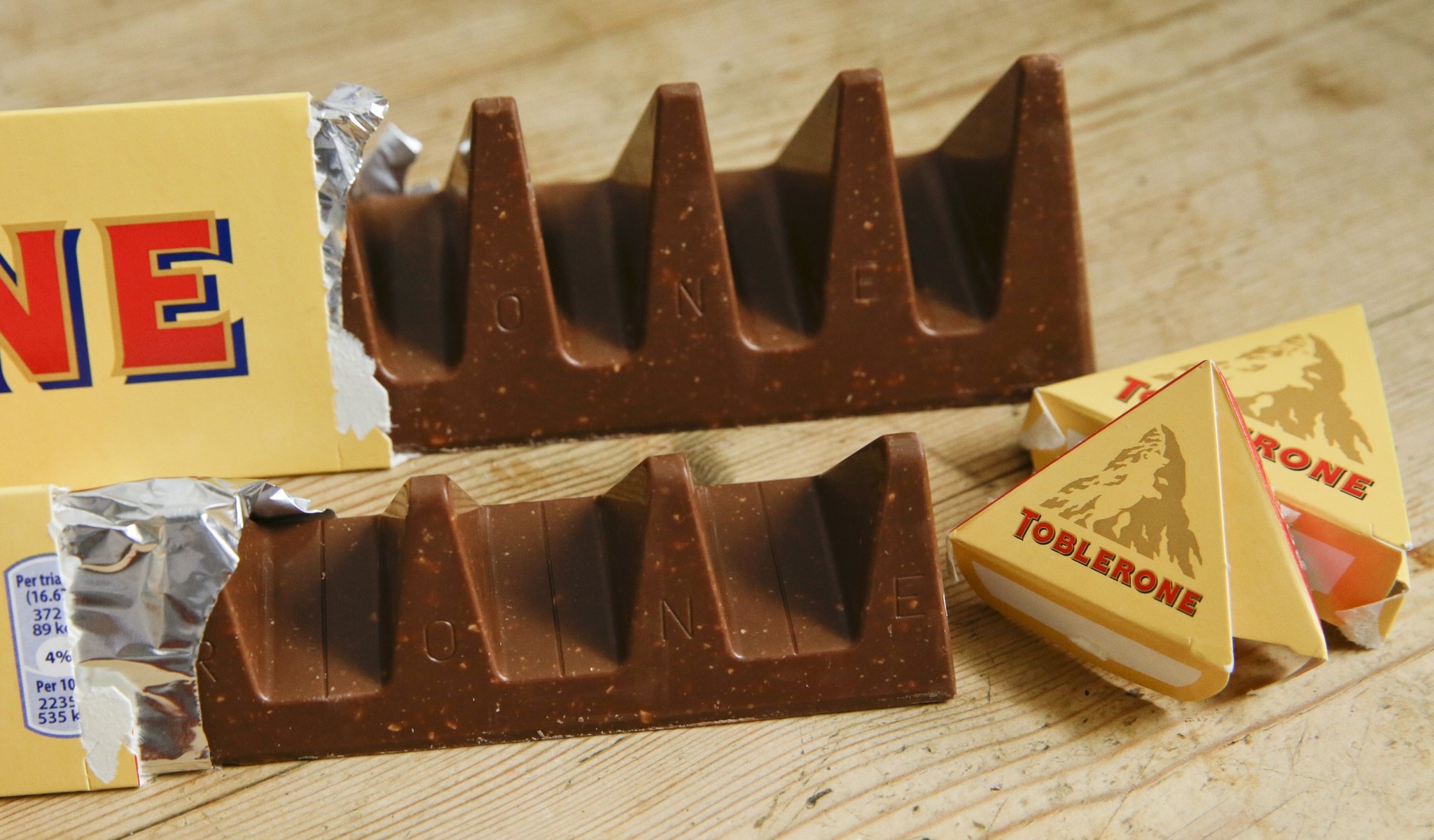 In this photo illustration two bars of the Toblerone Swiss chocolate are shown, at front is the new style 150 gram bar showing the reduction in triangular pieces. (AP Photo)