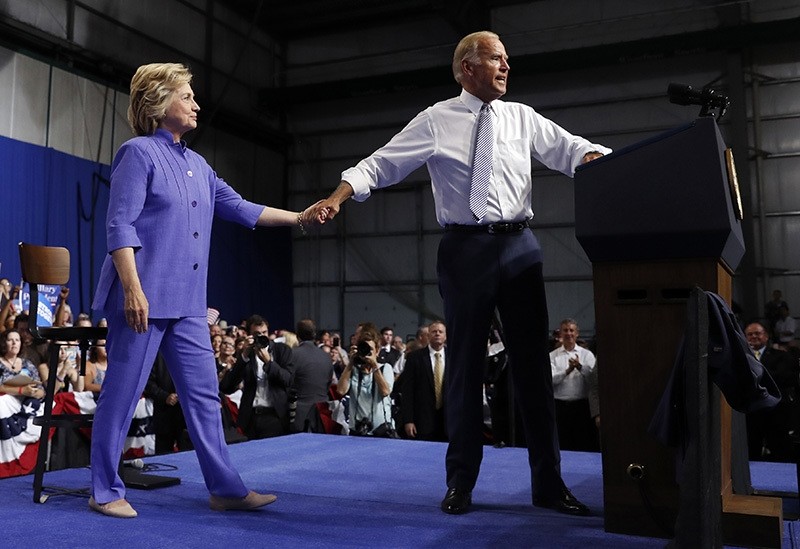 Vice President Joe Biden takes Democratic presidential candidate Hillary Clinton's hand as he speaks at a campaign event at Riverfront Sports in Scranton, Pa., Monday, Aug. 15, 2016. (AP Photo)