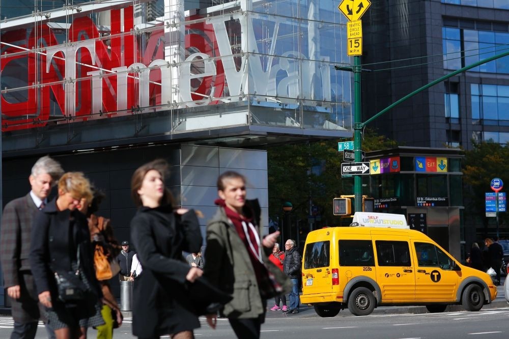 Pedestrians walk past the Time Warner Inc. Center in New York.