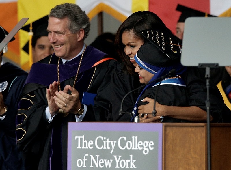 Michelle Obama embraces 2016 Salutatorian Orubba Almansouri, who was born and raised in Yemen, at the City College of New York's commencement ceremony in the Harlem section of Manhattan, New York, U.S., June 3, 2016. (AP Photo)