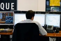 A trader checks his screens at investment bank Saxo Banque in Paris. European stocks rallied and the pound hit its highest level on Thursday as markets expected the Remain camp to come out on top in Britain's referendum on EU membership.