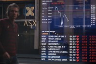 A man looks at the fluctuation in the share prices through a stock exchange window in Sydney on June 24, 2016.  (AFP Photo)