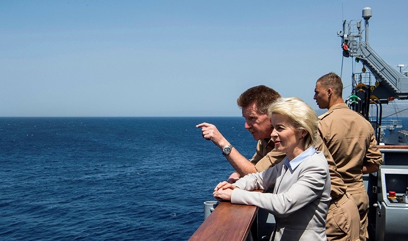 German Defence Minister Leyen (C), German Flotilla Admiral Klein (L) look out from the deck of the German navy support ship Bonn, in Aegean Sea, off Turkish coast, April 20, 2016. (Reuters)
