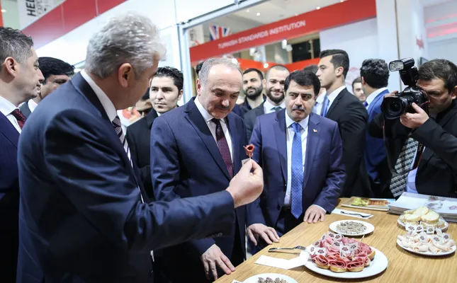 Minister of Science, Industry and Technology, Faruk Özlü, (second from the left), visits the stands in the exhibition area at the World Halal Summit in Istanbul.