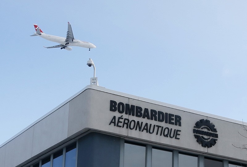 A plane flies over a Bombardier plant in Montreal, Quebec, Canada on January 21, 2014. (Reuters Photo)