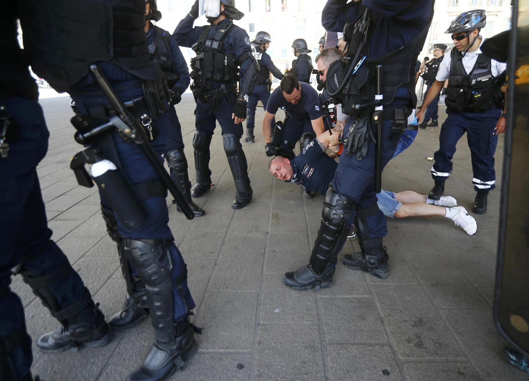 A Poland fan is detained by police at the old port of Marseille, France. (Reuters Photo)