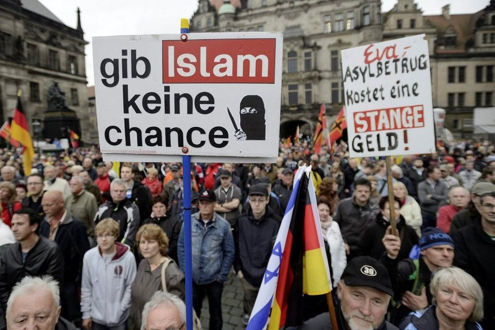 A demonstrator holds a sign that says: ,Give no chance to Islam, at a rally organized by pegida before elections in Dresden on June 7.