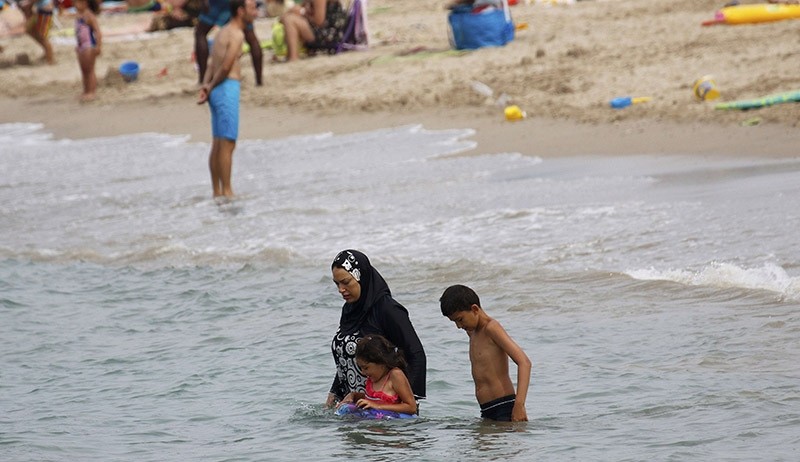 A Muslim woman wears a burkini, a swimsuit that leaves only the face, hands and feet exposed, on a beach in Marseille, France, August 17, 2016 (Reuters Photo)
