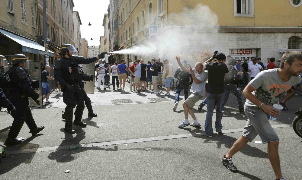 Police use tear gas on supporters near port of Marseille before the game.
