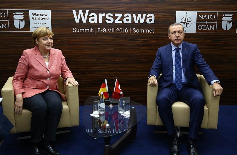 German Chancellor Angela Merkel meets President Recep Tayyip Erdou011fan in Warsaw, Polan during NATO summit on July8-9 IHA Photo