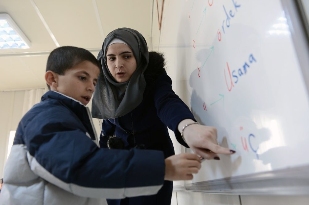 A Syrian teacher with her student at a refugee camp in the city of Malatya.