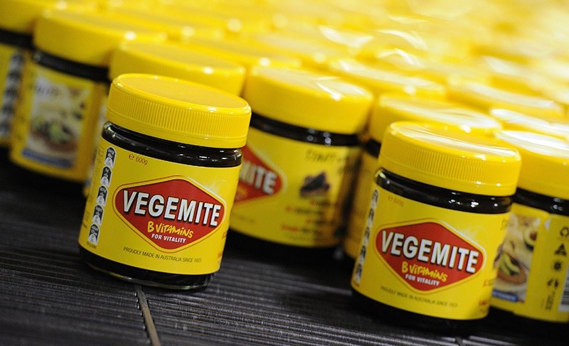  A file photo dated 24 October 2013 shows Vegemite jars rolling along production line at the Vegemite factory in Melbourne, Victoria, Australia (AP Photo)