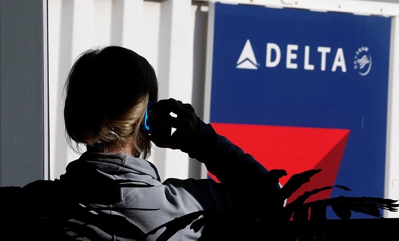A passenger talks on her phone at a Delta Airlines gate a day before the annual Thanksgiving Day holiday at the Salt Lake City international airport, in Salt Lake City, Utah November 21, 2012. (Reuters Photo)