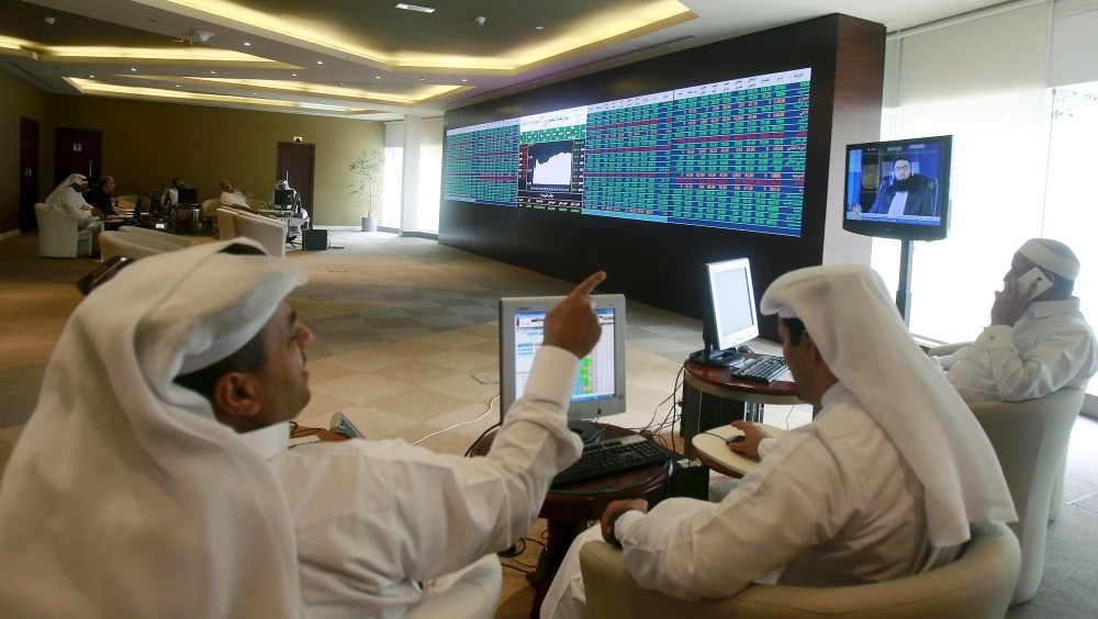 Gulf investors, such as these seen watching an electronic share price display at the Doha Stock Exchange in downtown Doha, Qatar, are among those expacted to be invited by the government to promote Sukuks.