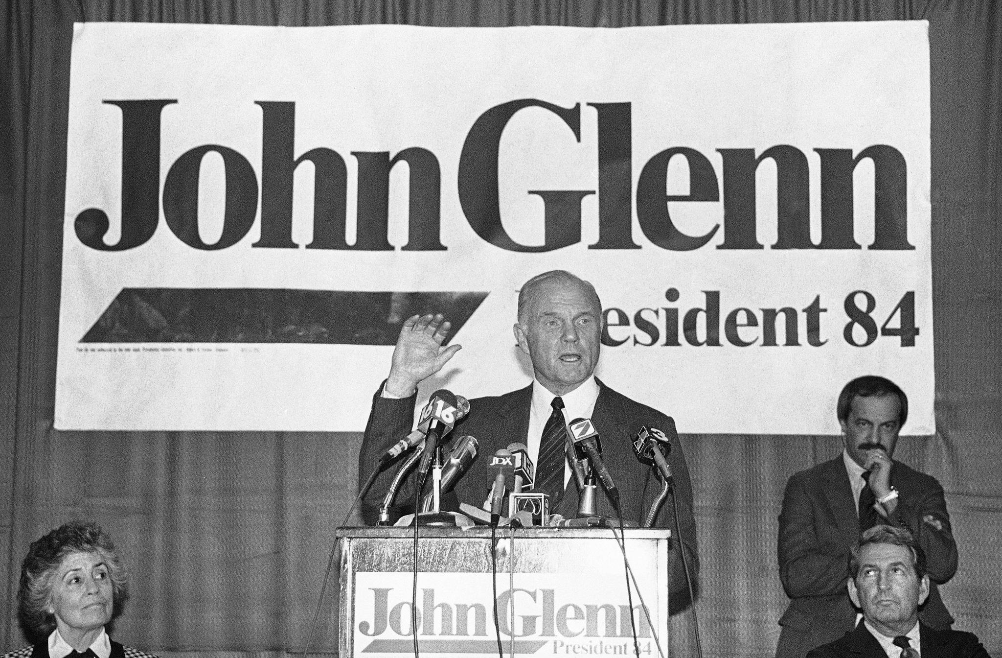 In this Tuesday, Jan. 18, 1984 file photo, Sen. John Glenn, D-Ohio, answers questions from the press in Jackson, Miss. (AP Photo)