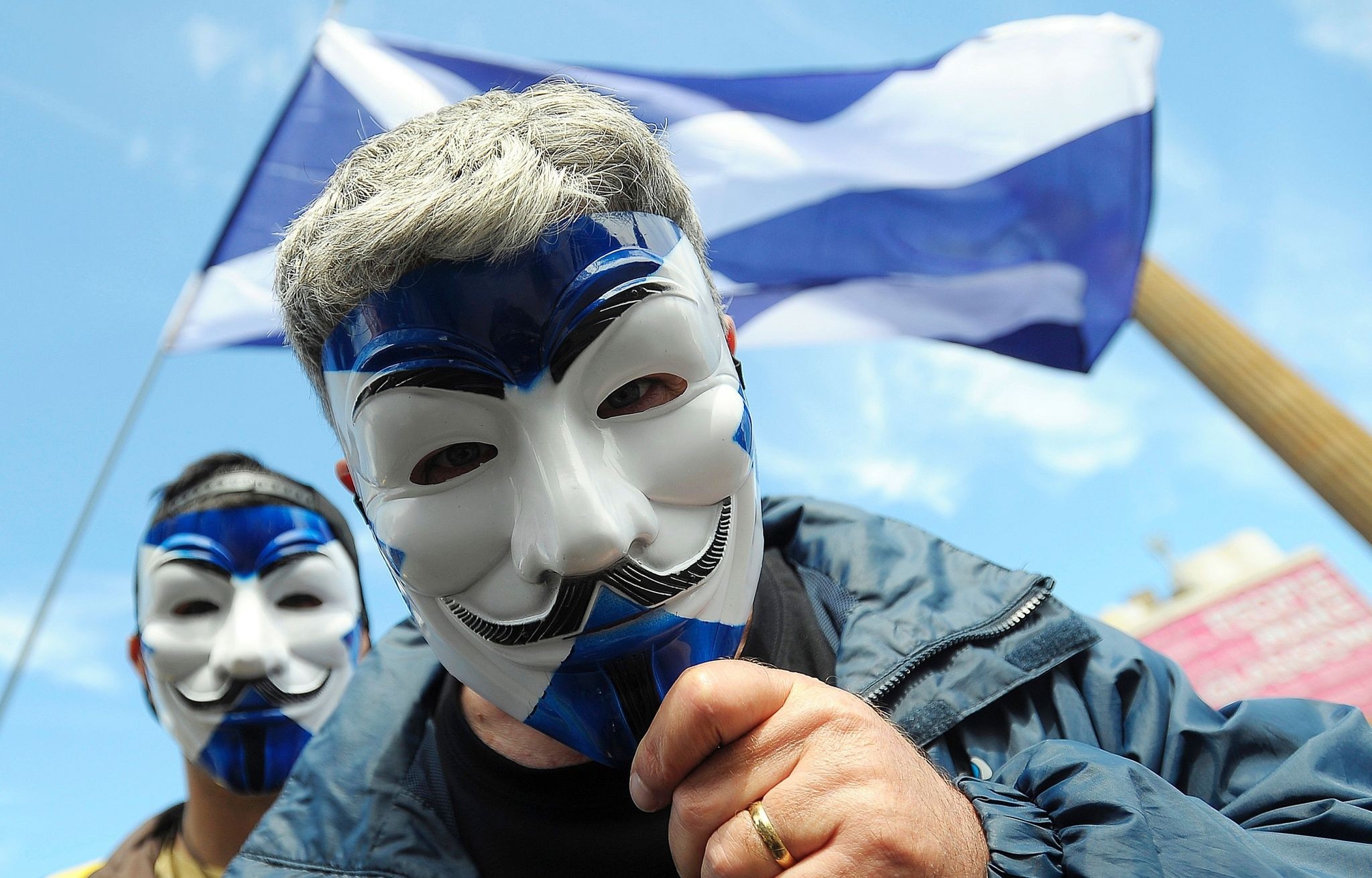 Pro-Scottish Independence supporters with Scottish Saltire flag masks pose for a picture at a rally in George Square in Glasgow, Scotland on July 30, 2016. (AFP Photo) 