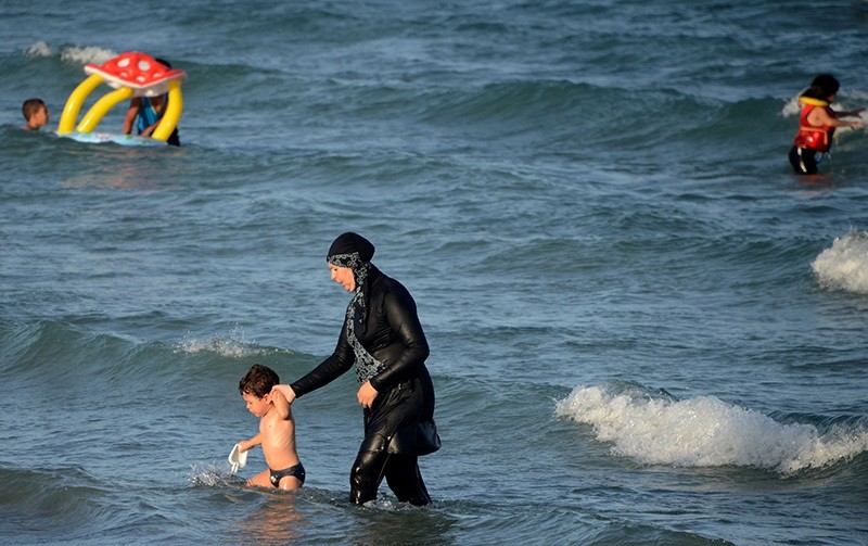 A Muslim woman wears a burkini on a beach in in Marseille, France, Aug. 17, 2015 (AFP Photo)