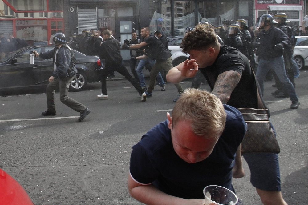 French police disperse a crowd of football hooligans in Lille, France.