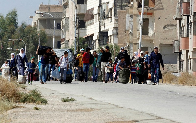 Syrians leave the Moadamiyeh suburb of Damascus, Syria, on Friday, Sept. 2, 2016. (AP Photo)
