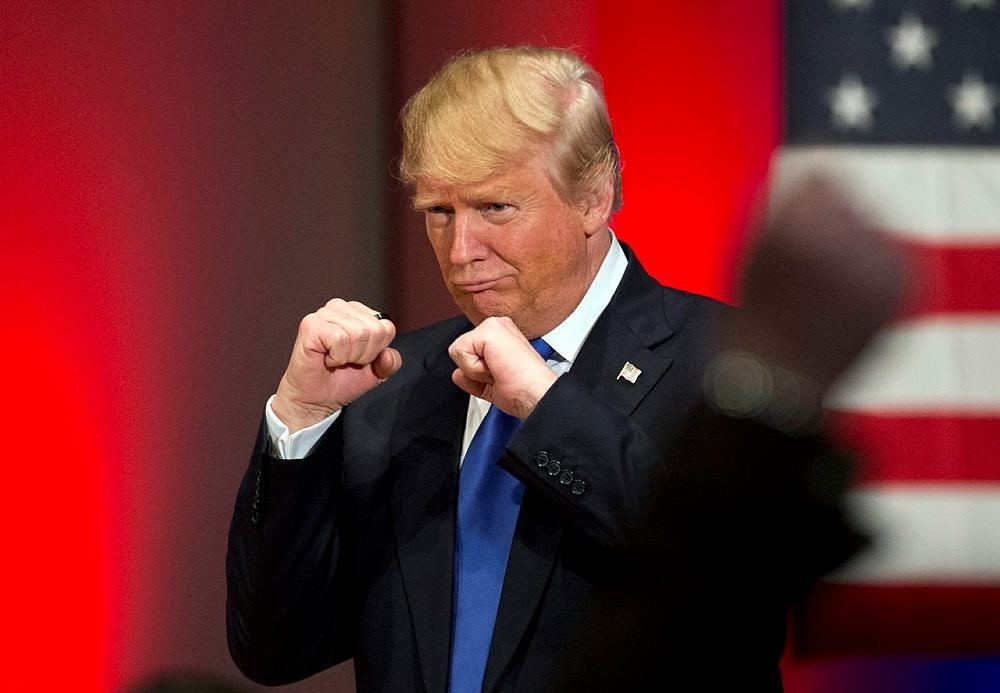 In this Jan. 28, 2016, file photo, Republican presidential candidate Donald Trump poses with a ring given to him by a group of veterans during a campaign event on the campus of Drake University in Des Moines, Iowa. (AP Photo)