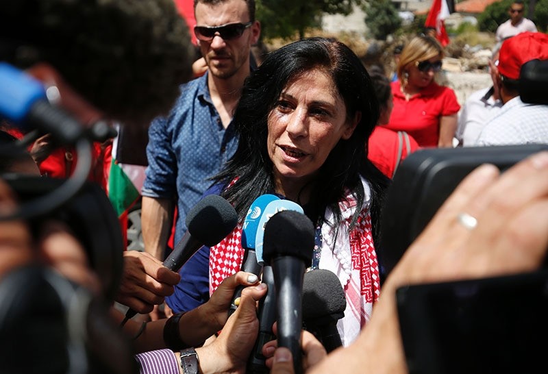 Khalida Jarrar greets speaks to reporters in her hometown, the West Bank city of Ramallah, following her release from an Israeli jail on June 3, 2016 (AFP)