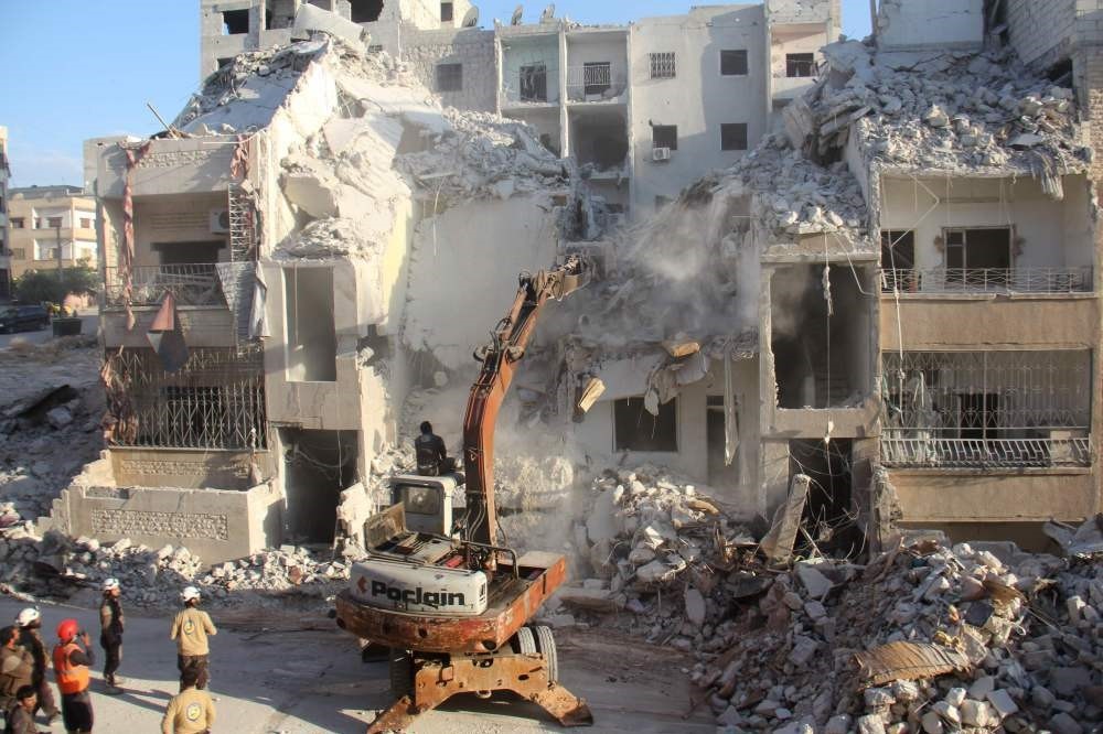 Syrian Civil Defense members search for survivors amid the rubble following reported Russian airstrikes on the Syrian northwestern city of Idlib on May 31.