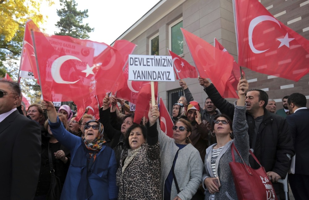 Turkish citizens staged a demonstration outside the French embassy in Ankara to protest France's support for PKK. The placard reads: ,We are with our State., 