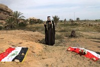 In this April 3, 2015 file photo, an Iraqi man prays for his slain relative, at the site of a mass grave, believed to contain the bodies of Iraqi soldiers killed by Daesh  AP Photo