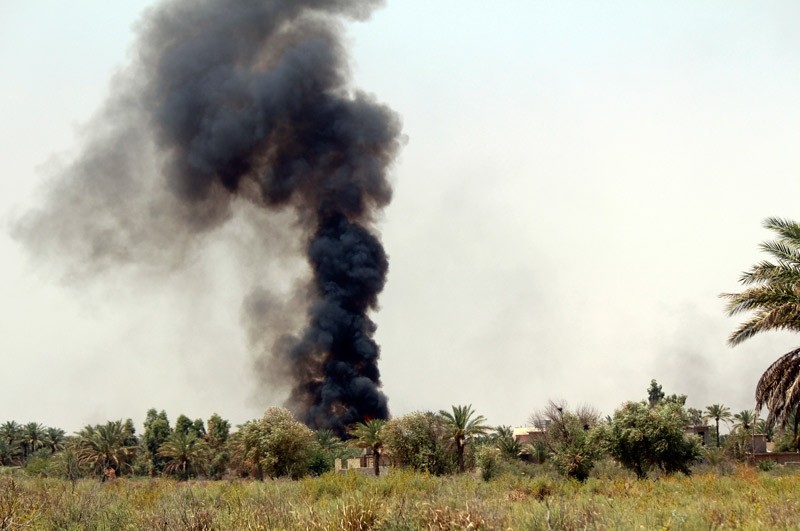 Smoke rises as Iraqi security forces backed by allied Shiite Popular Mobilization forces and Sunni tribal fighters attack Islamic State positions at Khalidiya Island in Anbar province, Iraq, Monday, Aug. 1, 2016.  AP Photo